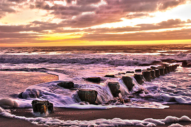 HDR Sunrise over the Atlantic Beach Landscape Sea foam  Pier stock photo