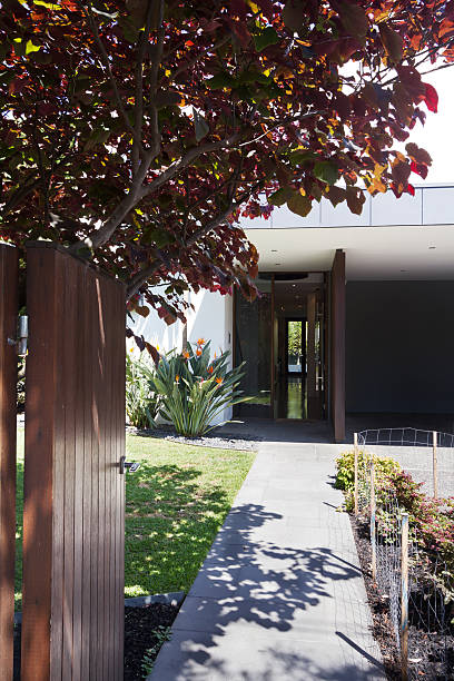 istock Front gate opening to show a beautiful contemporary home 499306018