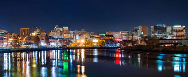 Wilmington skyline panorama by night, reflected in Christiana River. Wilmington is the largest city in the state of Delaware.