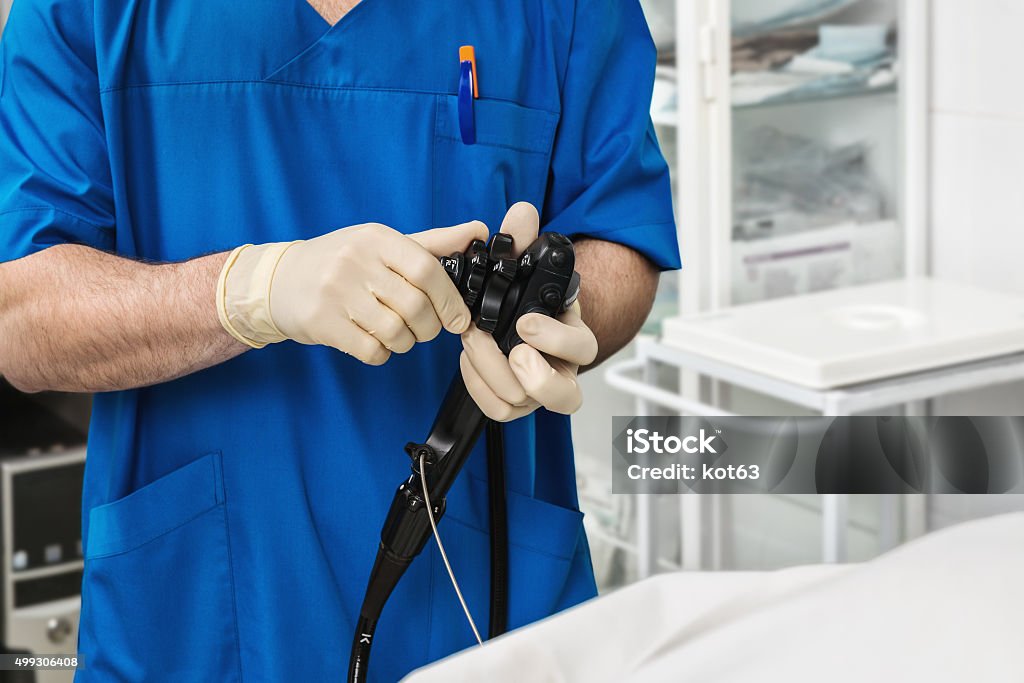 The endoscope is in the hands of a doctor. Doctor Gastroenterologist holds the endoscope. Endoscope Stock Photo