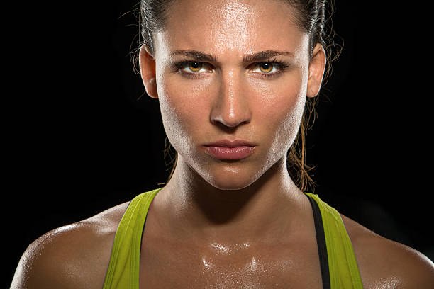 Intense stare eyes determined athlete champion glare headshot powerful Strong strength confidence power determination relentless conviction female athlete trainer conceptual Boxer fighter MMA tough woman athlete exercise training posing portrait champion intimidating Intense stare eyes determined athlete champion glare head shot sweaty confident woman female powerful fighter close up mixed martial arts photos stock pictures, royalty-free photos & images