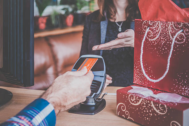 Man Paying With NFC Technology on Credit Card in Store