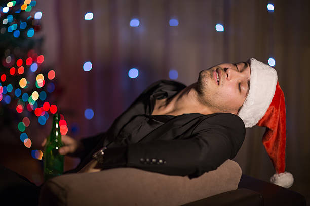istock Drinking and sleepy Christmas man in santa's hat 499309694