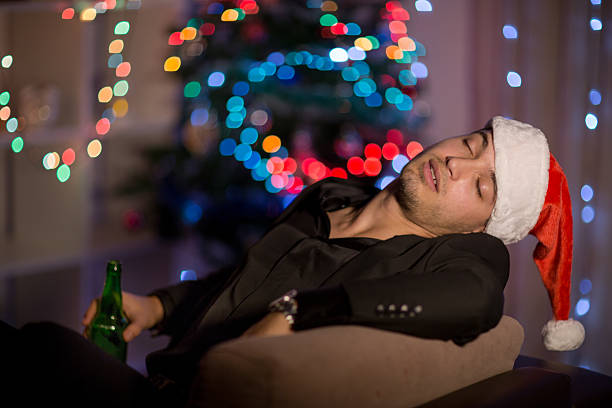 istock Drinking and sleepy Christmas man in santa's hat 499309900