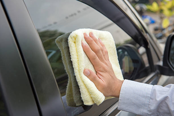 istock Hand cleaning the car window 499310898