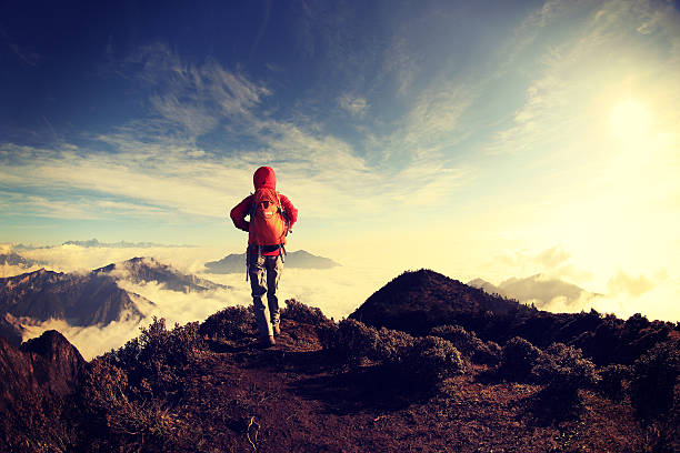 istock young woman hiker on beautiful rolling clouds mountain peak 499312178