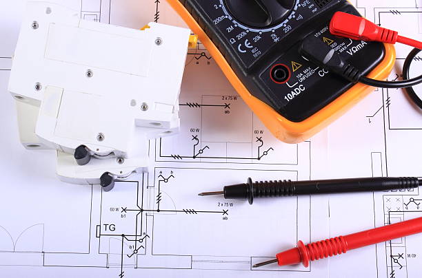 istock Multimeter and electric fuse on construction drawing 499314286