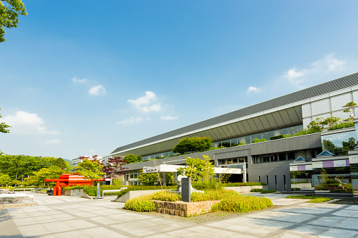 Kyoto, Japan - June 12, 2015: Front facade of Miyako Messe, a convention center and international exhibition hall housing the Museum of Traditional Crafts on a sunny day