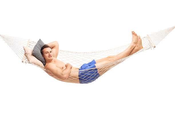 istock Carefree shirtless man lying on a hammock 499316554