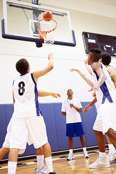 istock Male High School Basketball Team Playing Game 499330109