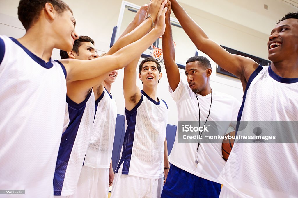 Male High School Basketball Team Having Team Talk With Coach Male High School Basketball Team Having Team Talk With Coach In A Huddle Huddling Stock Photo