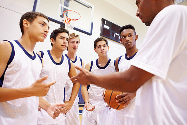 istock Male High School Basketball Team Having Team Talk With Coach 499330751