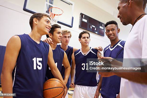 Männliche Highschoolbasketballteam Sprechen Sie Team Mit Trainer Stockfoto und mehr Bilder von Basketball