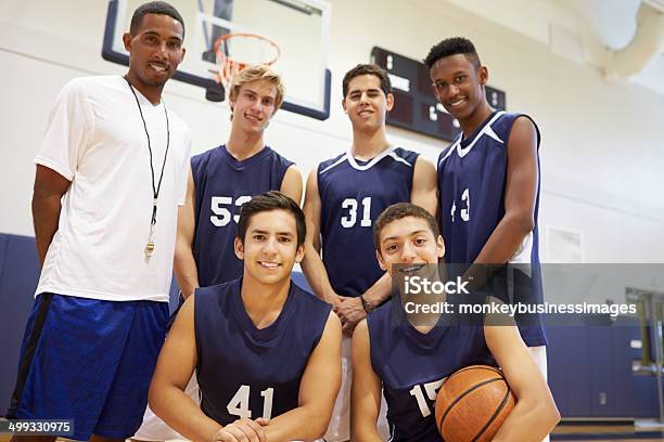 Members Of Male High School Basketball Team With Coach Stock Photo - Download Image Now