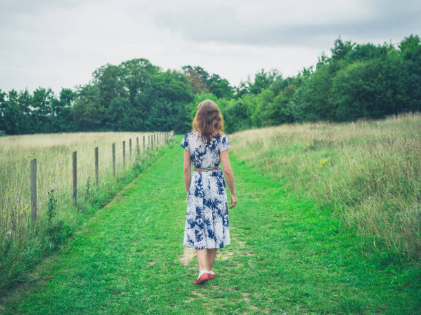 istock Young woman walking in the countryside 499331328
