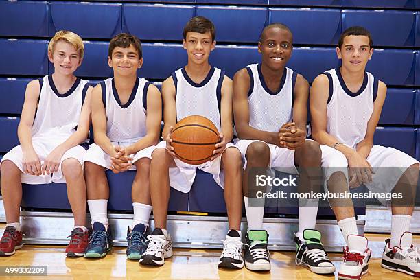 Members Of Male High School Basketball Team On Bench Stock Photo - Download Image Now