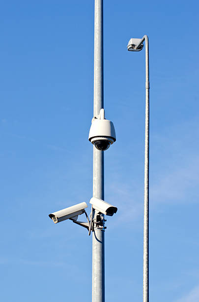 istock two security cameras on electric post and lamp 499334097