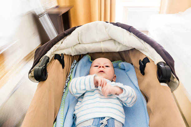 istock Little baby boy in moving stroller, indoors, motion blur 499334957