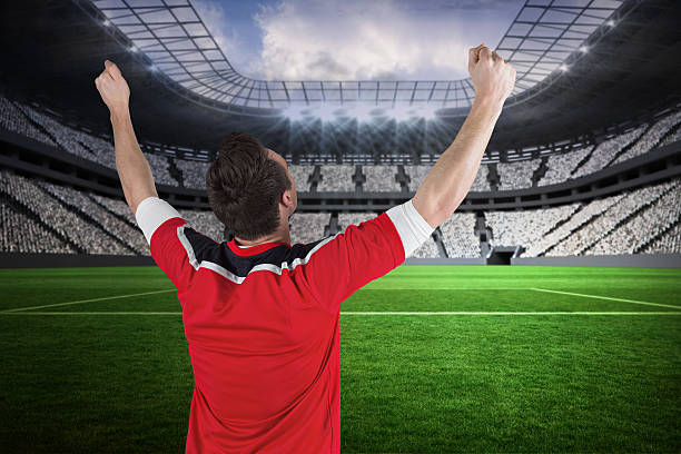 istock Excited football fan cheering 499335293