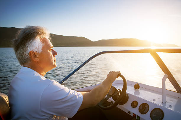 istock mature man driving speedboat 499335598