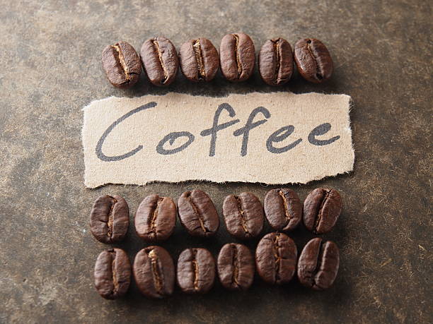 istock Coffee crop beans with paper on wood texture 499336151