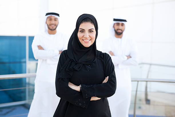 istock Confident Arab Woman Standing In Front Of Two Arab Men 499336198
