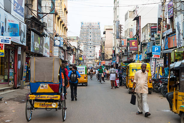 istock People, rickshaw, and bicycle traffic on Madurai street 499336473
