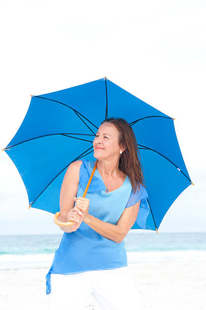 istock Portrait relaxed attractive mature woman beach 499337046