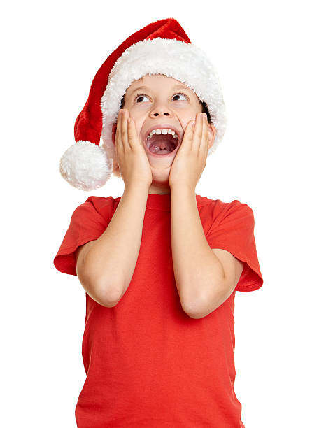 istock winter holiday christmas concept boy in santa hat on white 499337912