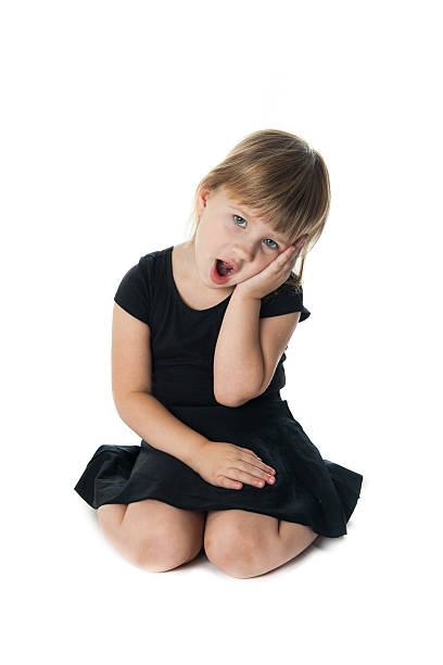 istock Girl in a black suit dancing on white background 499338784