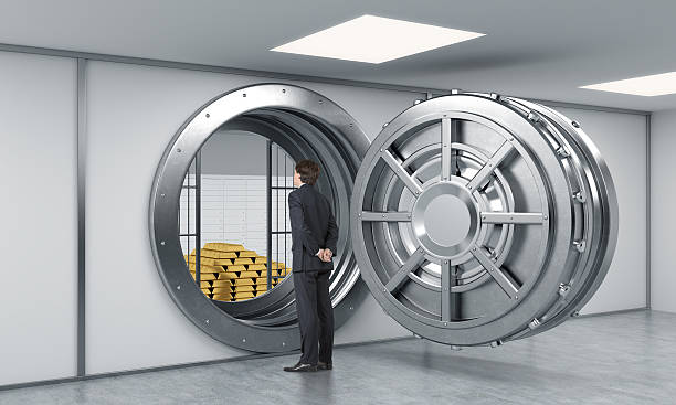 istock man standing in front of a big unlocked metal safe 499339284