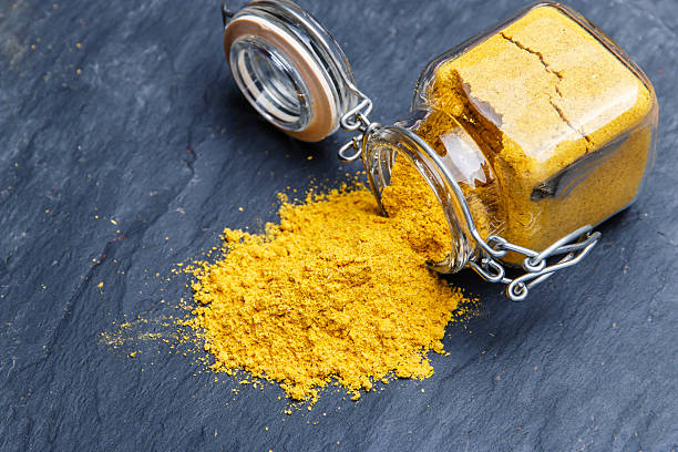istock powder seasoning spice turmeric on a black stone 499339960