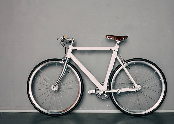 Fixed Gear  beautiful vintage bicycle stands next to grey background