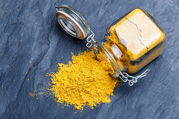 istock powder seasoning spice turmeric on a black stone 499340918