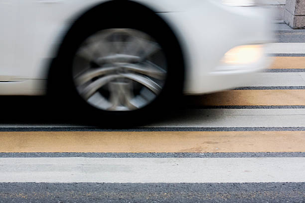 istock White car moving fast on zebra crossing. 499342630