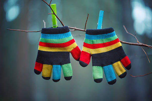 Little baby mittens/gloves hanging by a thread in winter outside