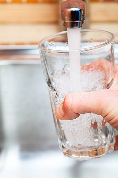 istock Filling up a glass with water from kitchen tap 499345030
