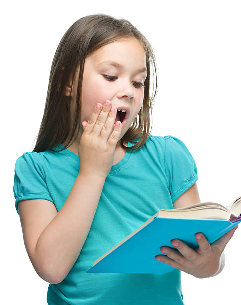 istock Cute girl is reading book 499356169