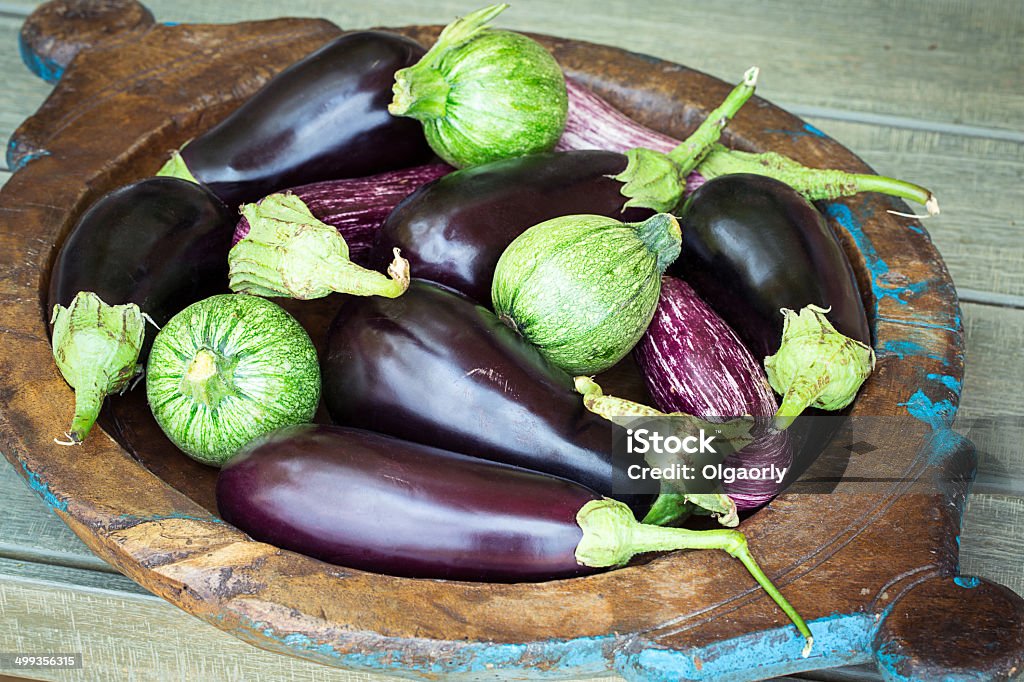 Eggplants and round zucchini on wooden plate Agriculture Stock Photo