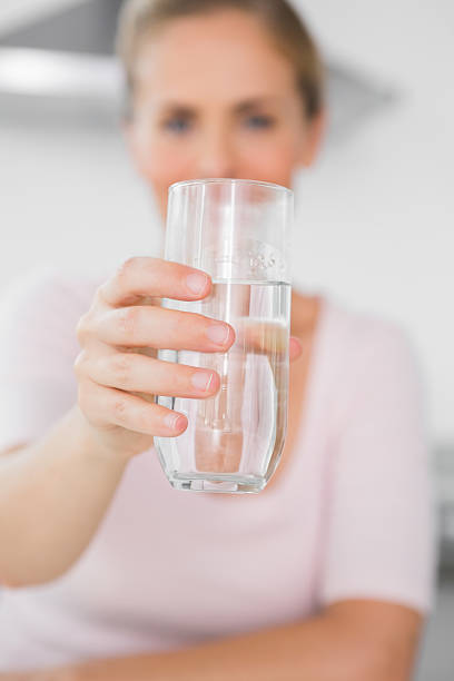 istock Blonde woman offering water 499356721