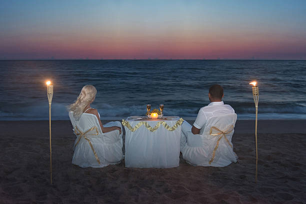istock Couple at sea beach during luxury romantic dinner with candles 499357251