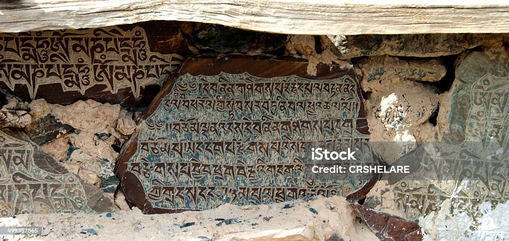 Buddhist Inscription Stone – Stone with Buddhist  Mantras  Buddhist Inscription Stone – Stone with Buddhist  Mantras Praying Stock Photo
