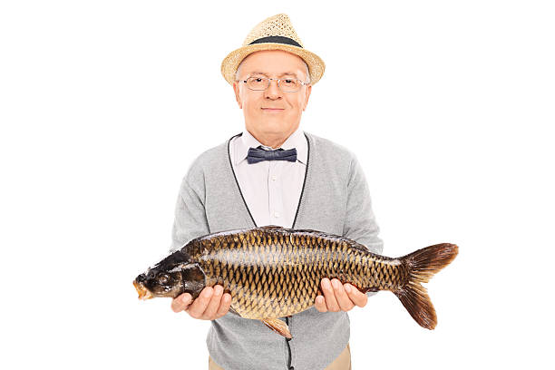 istock Senior gentleman holding a freshwater fish 499358439
