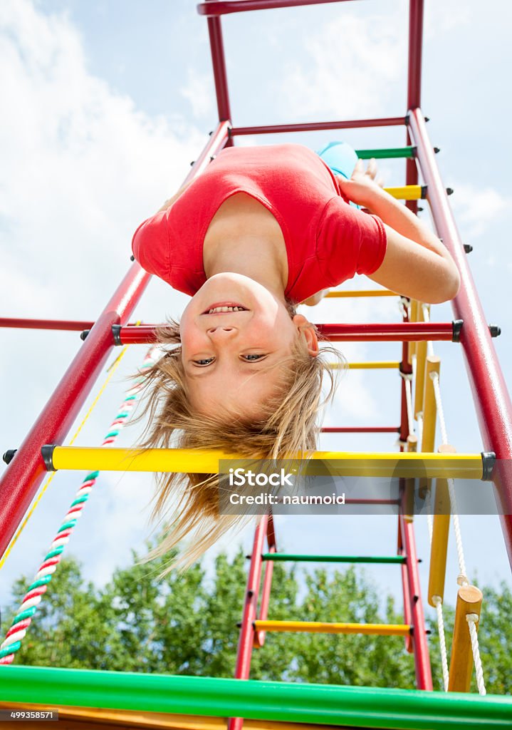 Happy child on a jungle gym Little girl having fun playing on monkey bars Active Lifestyle Stock Photo