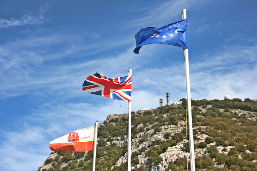 European, UK and Gibraltar flag, with the rock of Gibraltar in the background