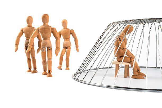 istock Wooden Mannequin isolated and trapped in a cage 499360443