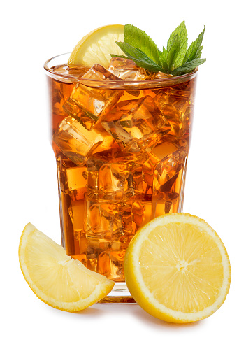 The glass of ice tea garnished with lemon and mint, isolated on white background.