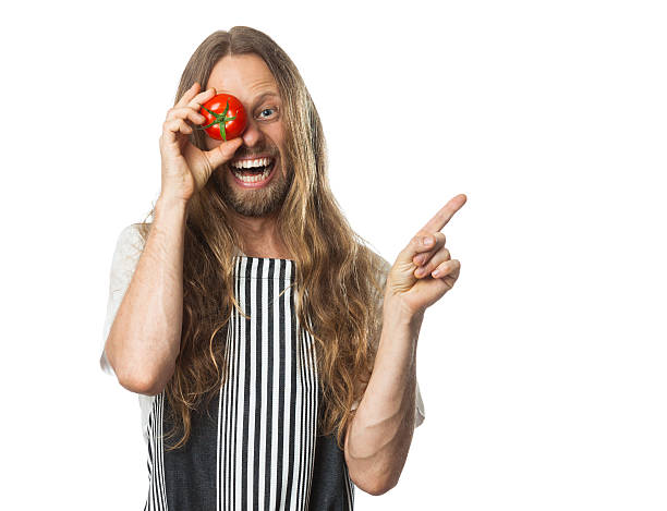 Silly hippie with tomato over eye pointing