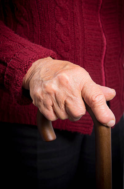 istock Old woman holding walking stick 499364536