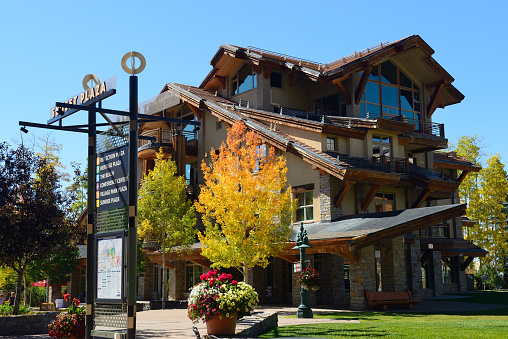 Telluride, USA - September 24, 2015.  View of Sunset Plaza with incidental people on left at Mountain Village in Telluride, Colorado. Mountain Village is an upscale community in Telluride which is a resort town surrounded by steep peaks of San Juan Mountains in the San Miguel County of southwestern Colorado and a popular tourist destination year-round, famous for its mountain scenery, art galleries, restaurants and top ranked ski facilities.